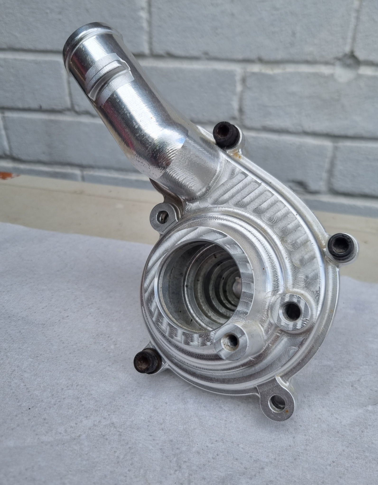 Machined aluminium housing or pump-style component with complex internal and external features