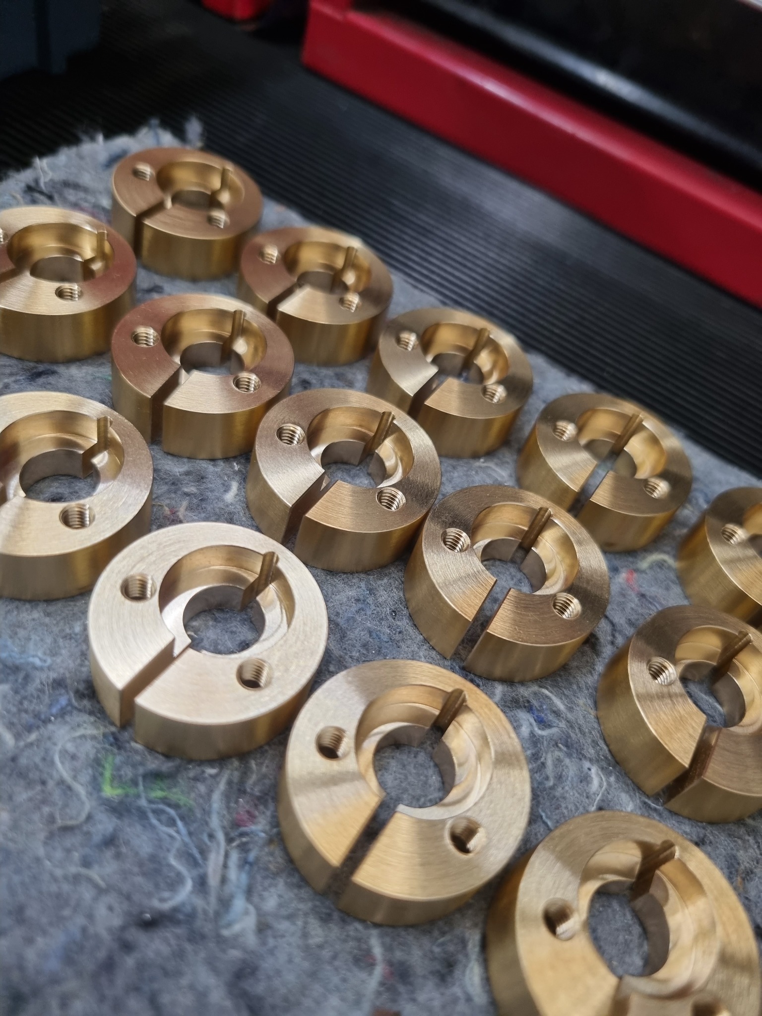Group of turned brass components with machined split features