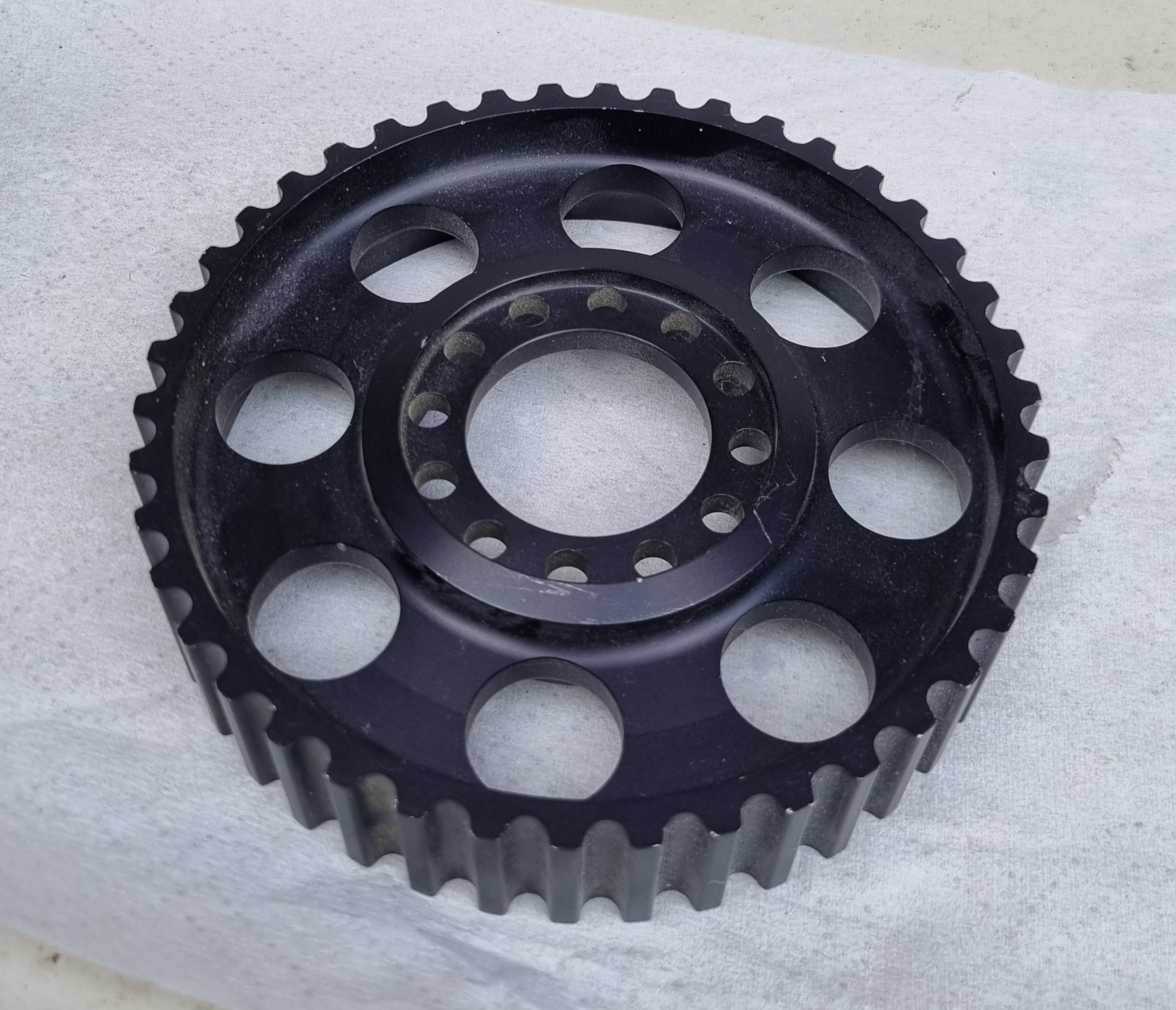 Black toothed machined wheel or pulley component