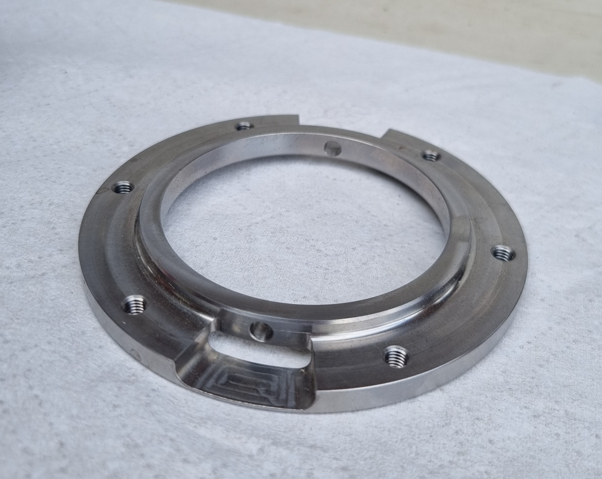 Machined circular ring component with threaded holes